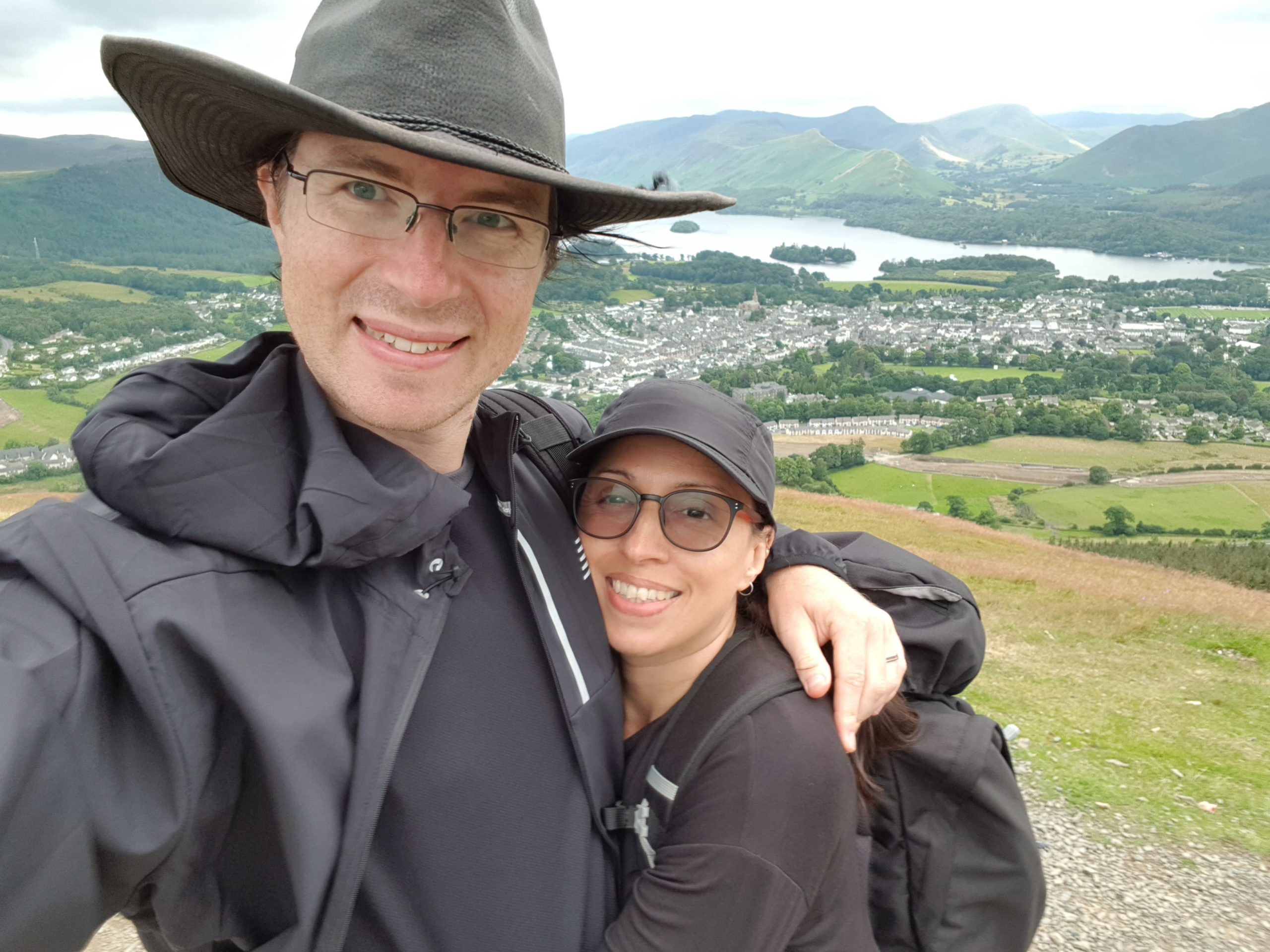 Two vegan hikers atop a hill in the Lake District overlooking Keswick