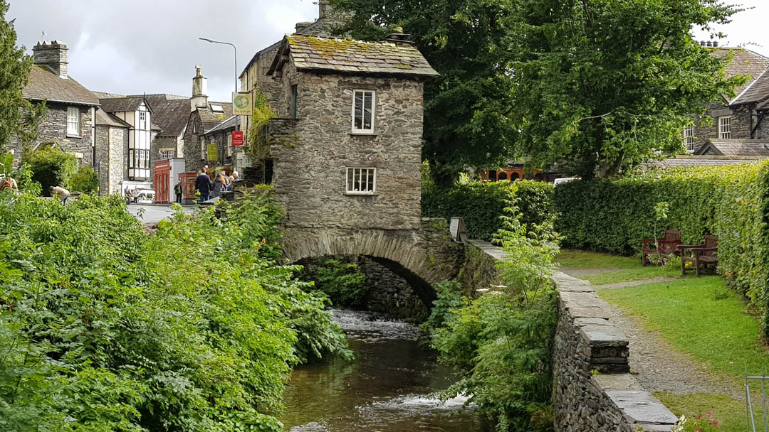 The Bridge House - a tiny stone house on a bridge across river in Ambleside